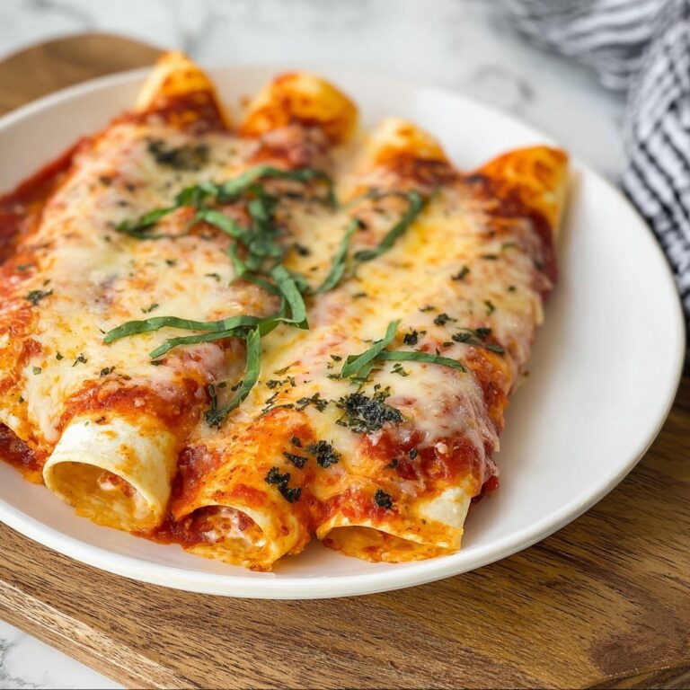 Cheesy Baked Manicotti with Marinara and Fresh Basil Recipe